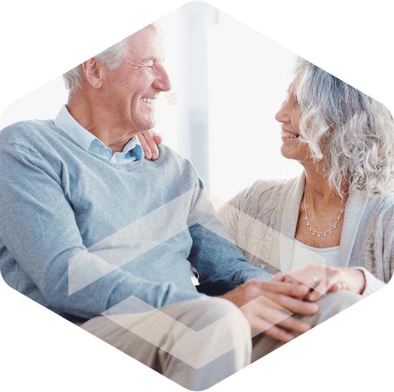 Caregiver smiling with an elderly resident