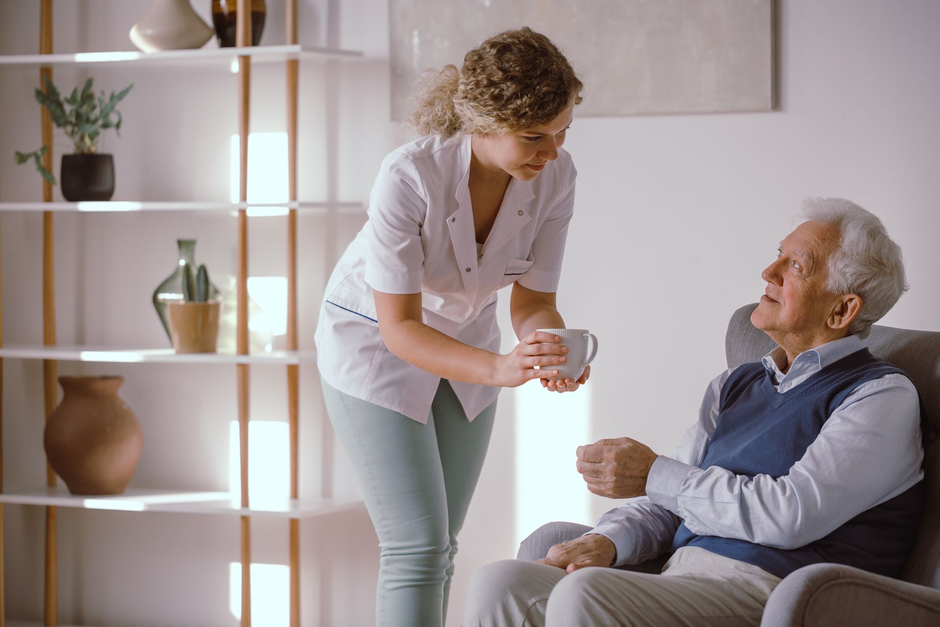 Caregiver assisting an elderly man