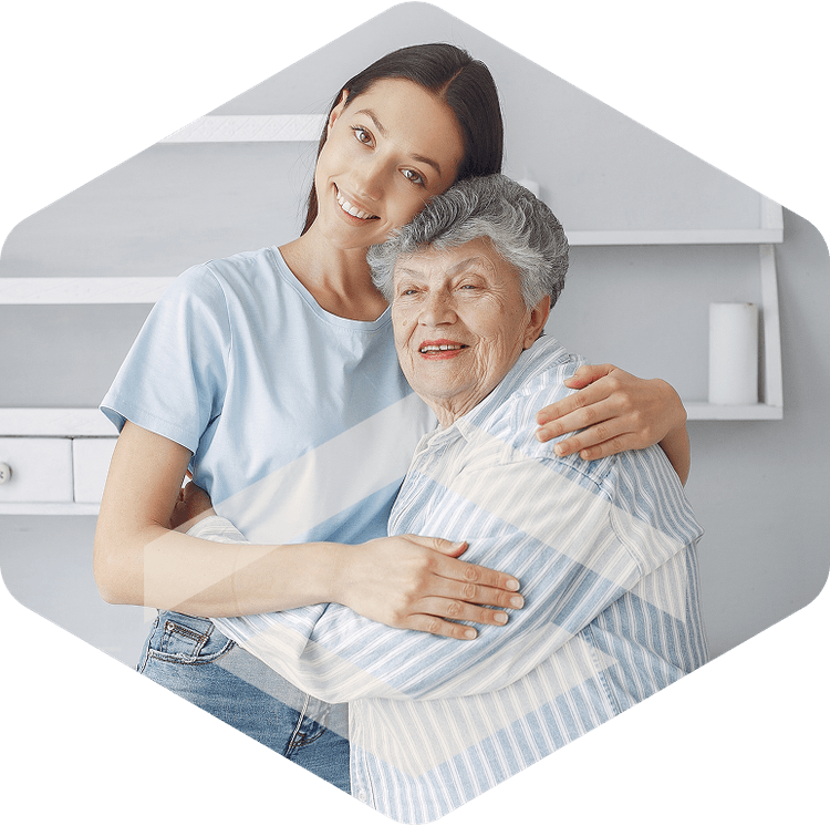 Caregiver embracing an elderly resident during hospice care