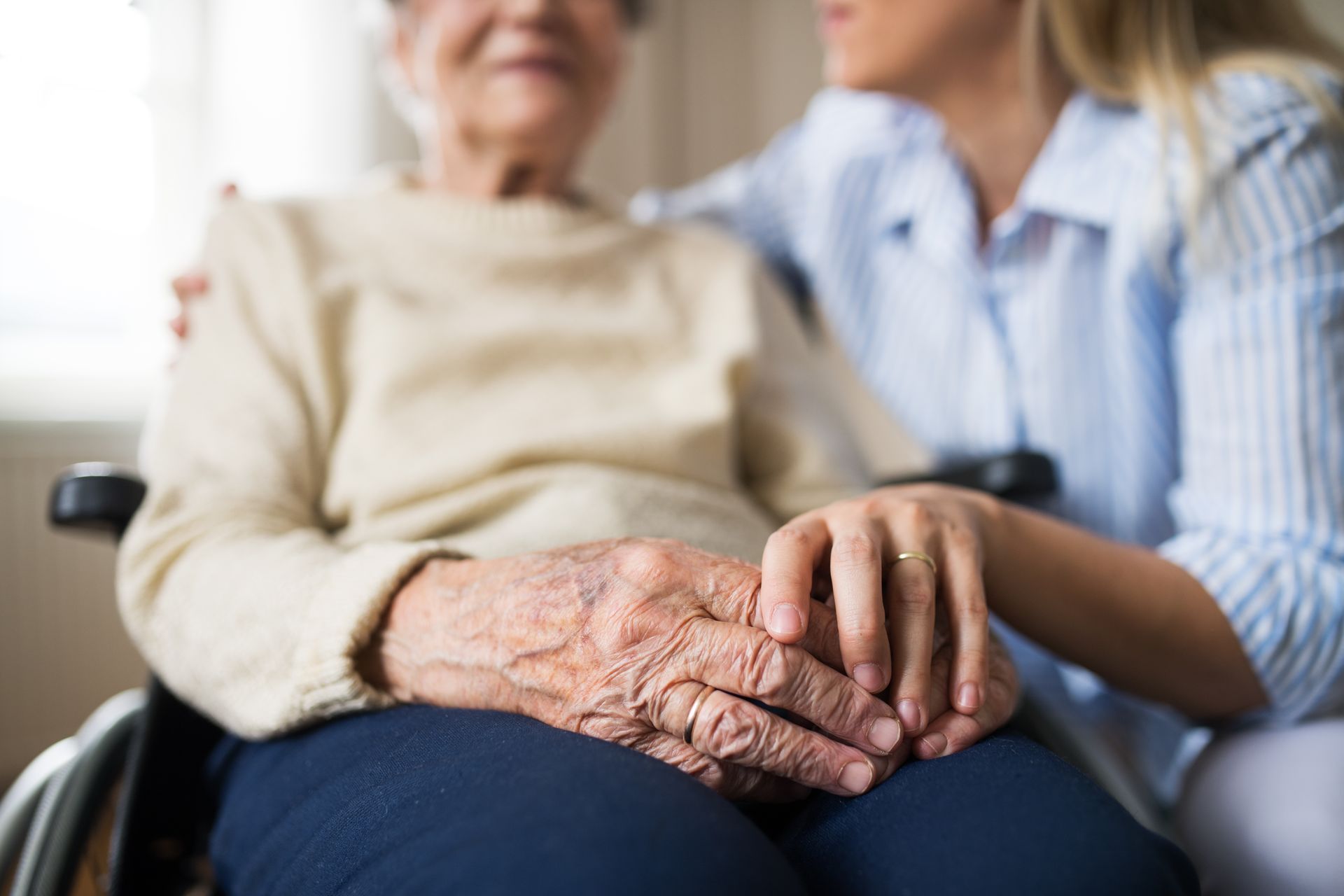 Caregiver supporting an elderly memory care resident