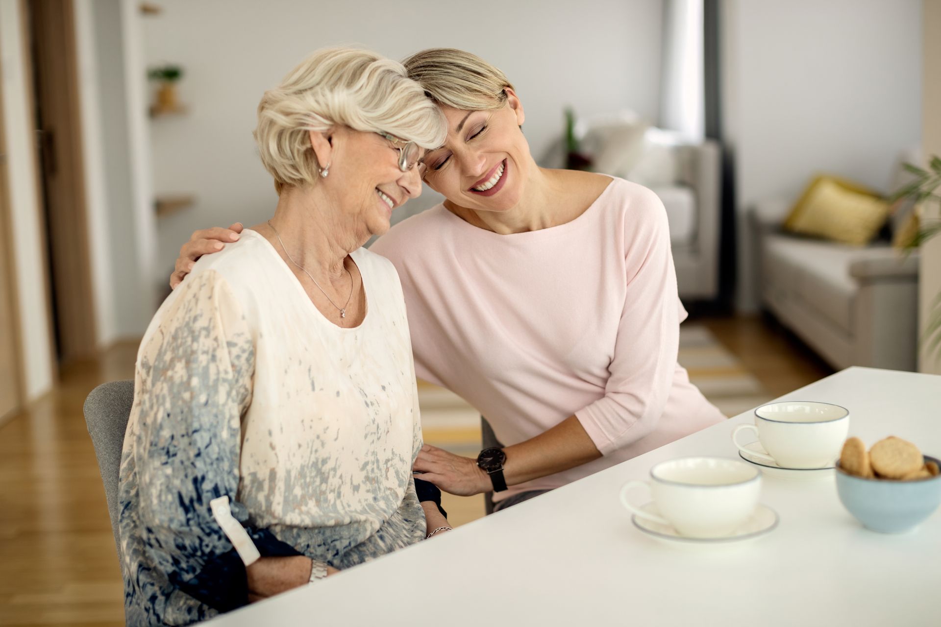 Adult daughter comforting elderly mother
