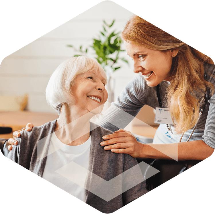 Nurse smiling with an elderly resident during skilled nursing care